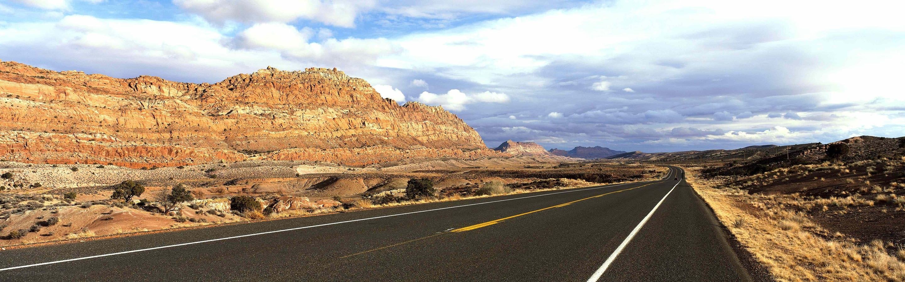 Desert highway with red rock formations