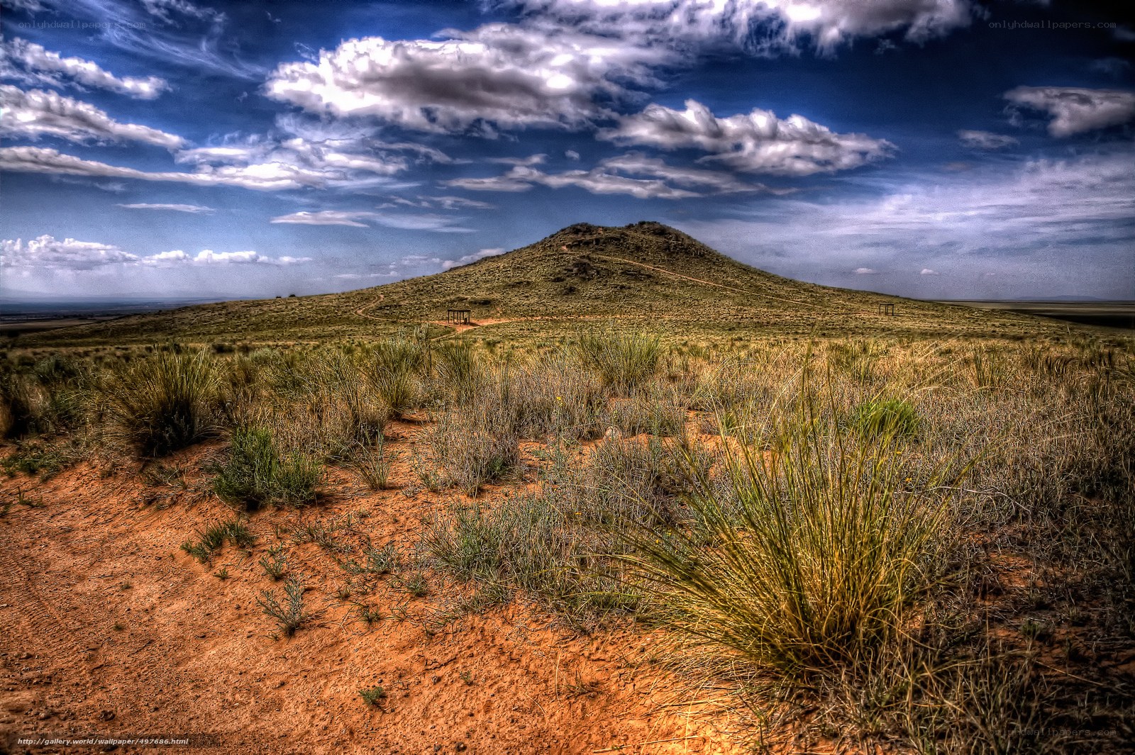 Desert hill under cloudy sky