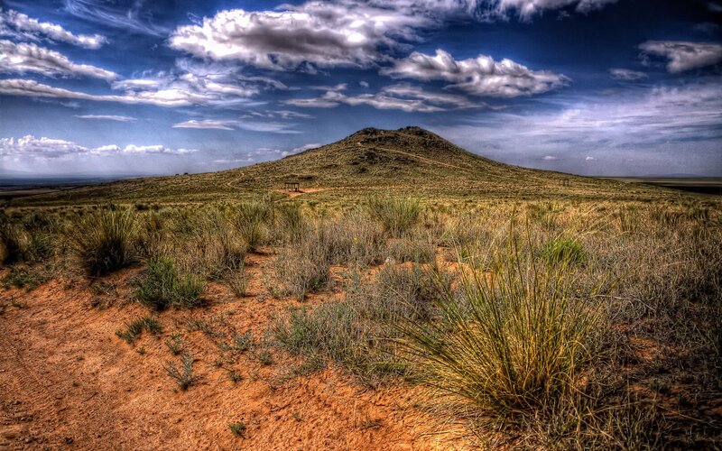Desert hill under cloudy sky