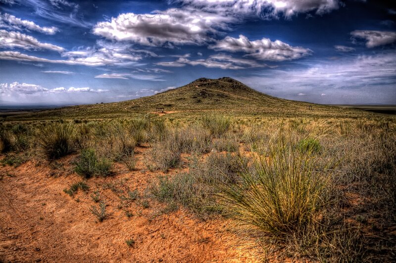 Desert hill under cloudy sky
