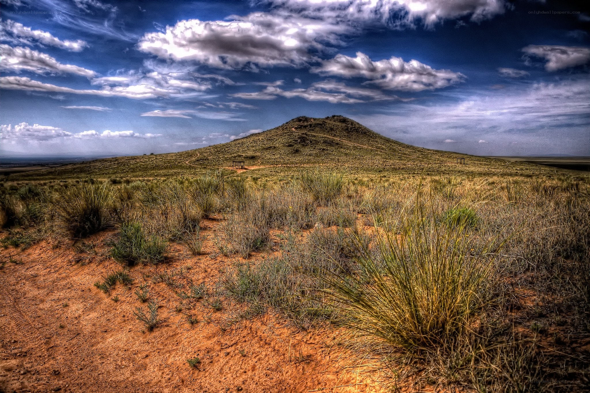 Desert hill under cloudy sky