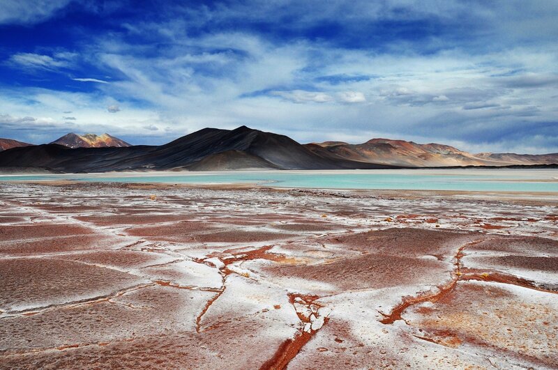 Desert lake with colorful mountains