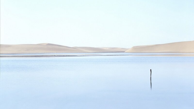 Desert lake with sand dunes