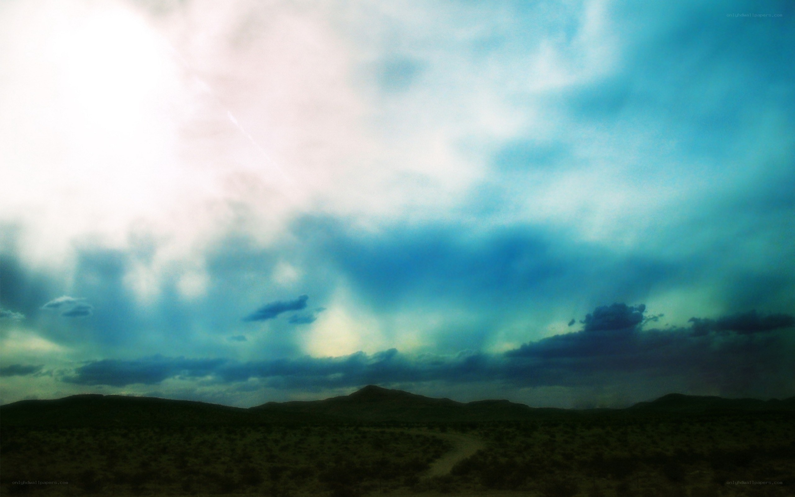 Desert landscape under stormy sky