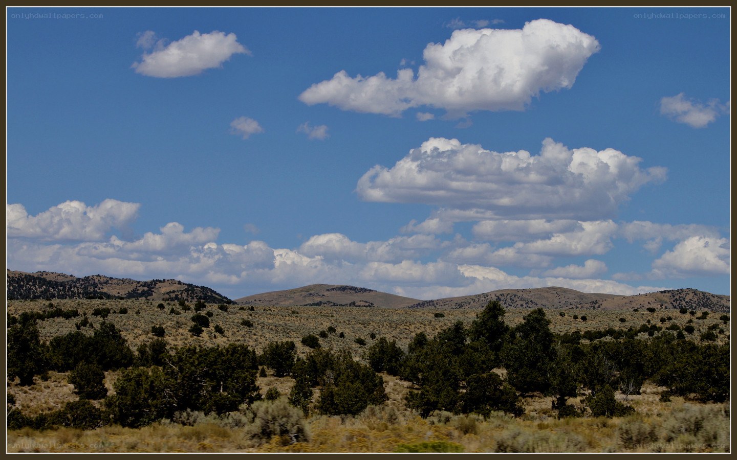 Desert landscape with hills and clouds