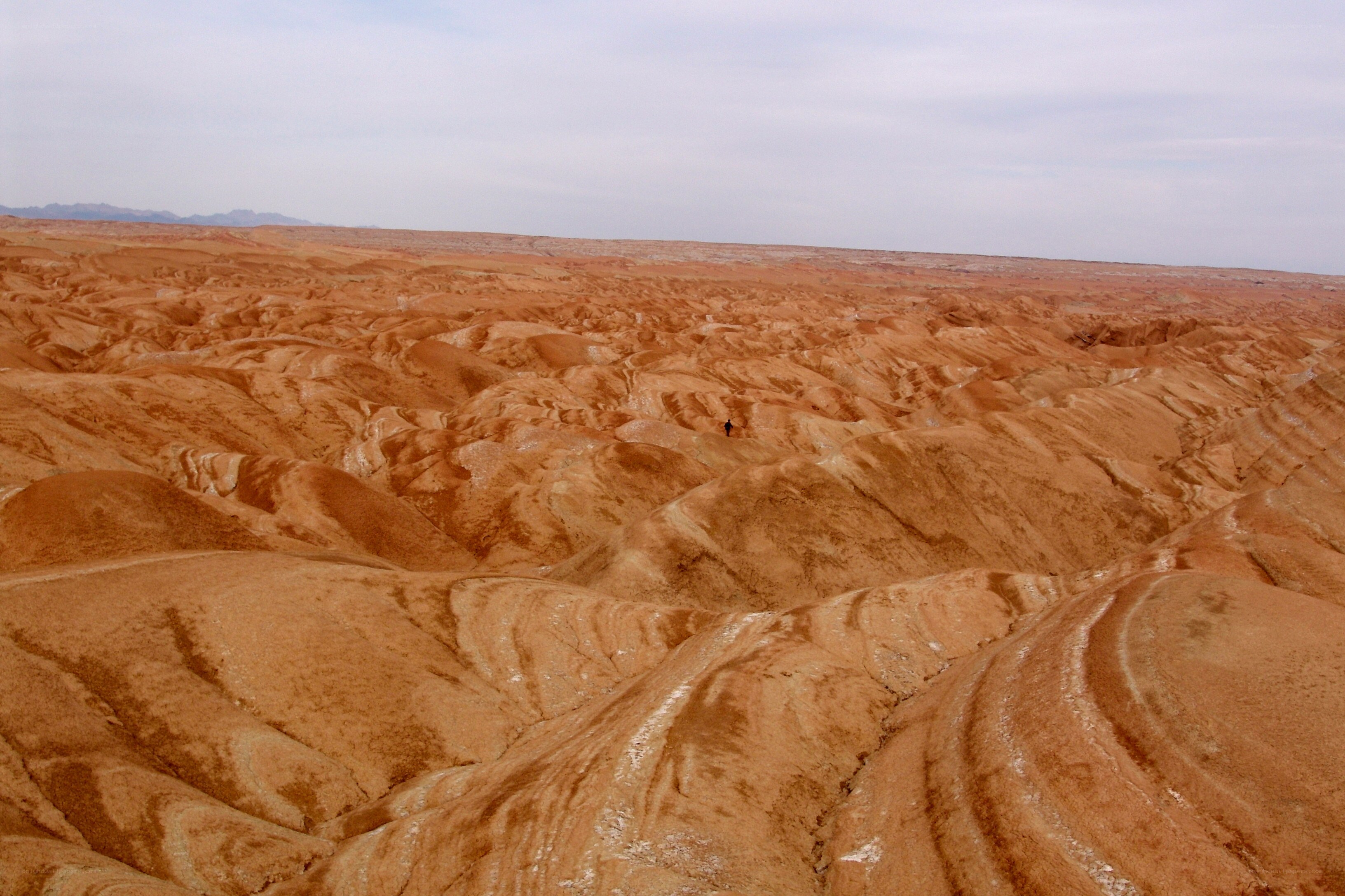 Desert landscape with lone hiker