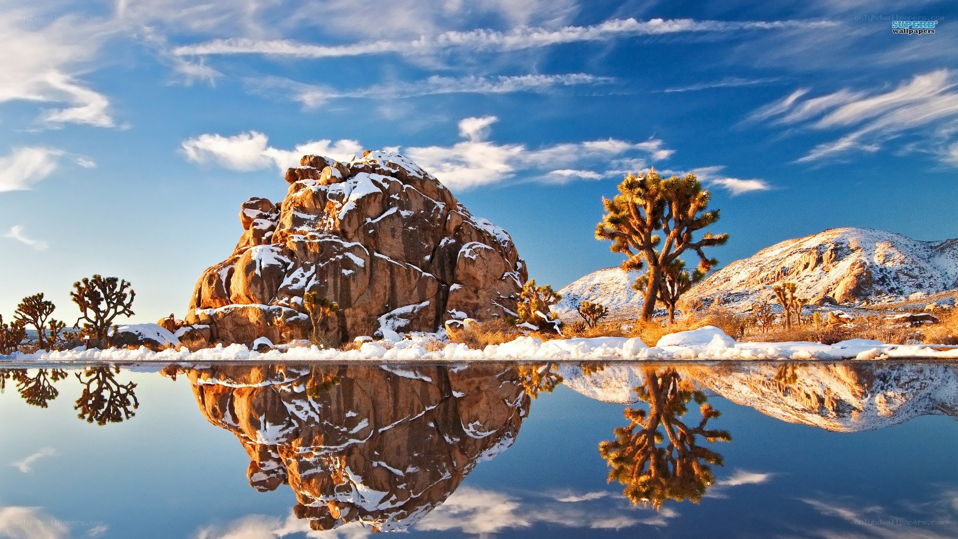 Desert landscape with snow and reflection