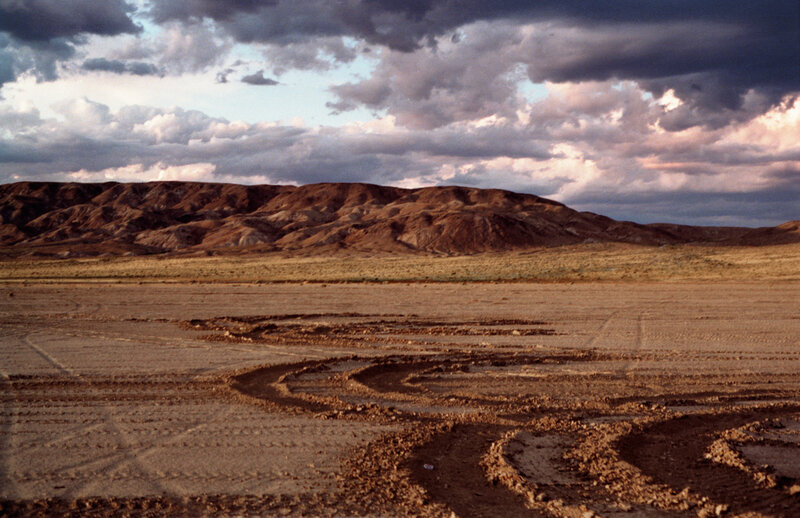 Desert landscape with tire tracks