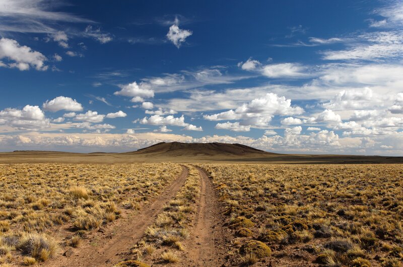 Desert path under cloudy sky