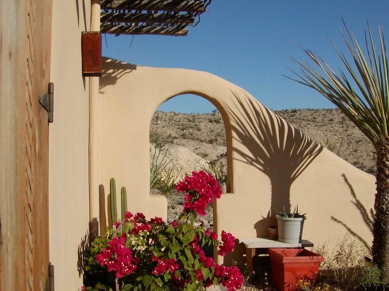 Desert patio with archway and flowers