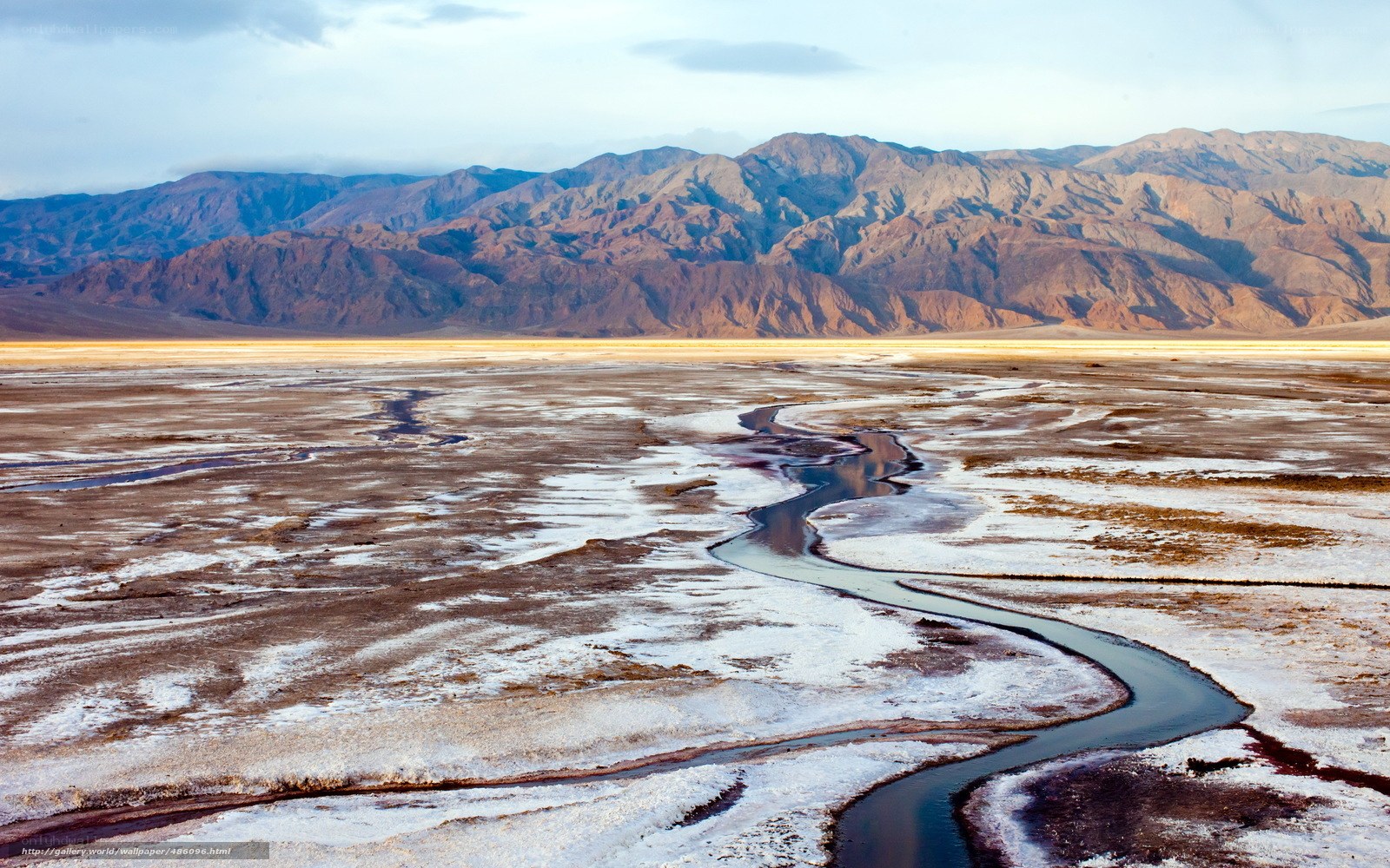 Desert river winding through salt flats