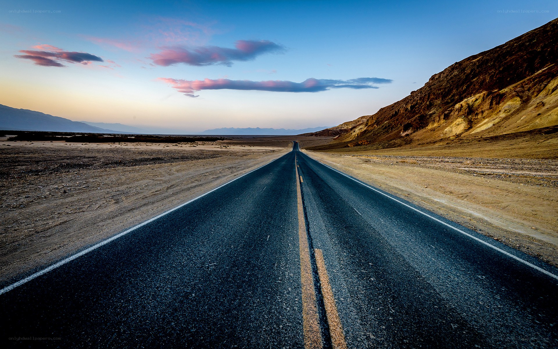 Desert road at sunset