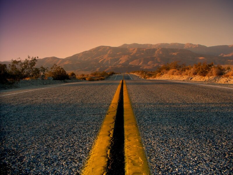 Desert road at sunset