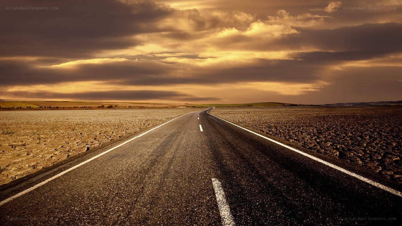 Desert road at sunset