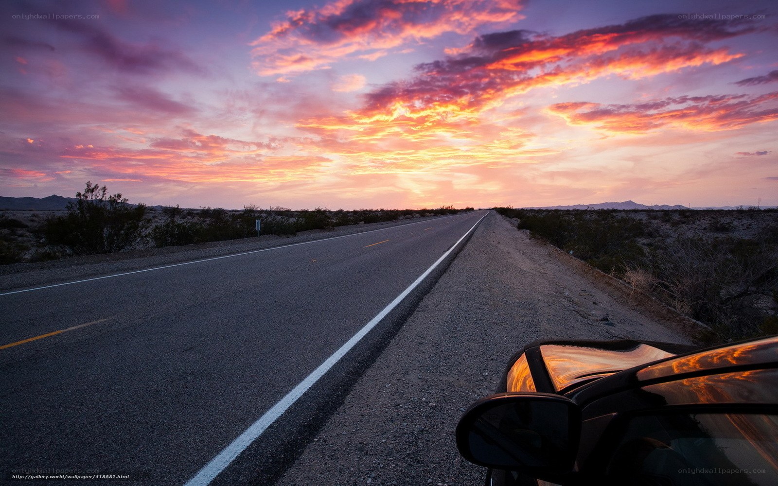 Desert road at sunset