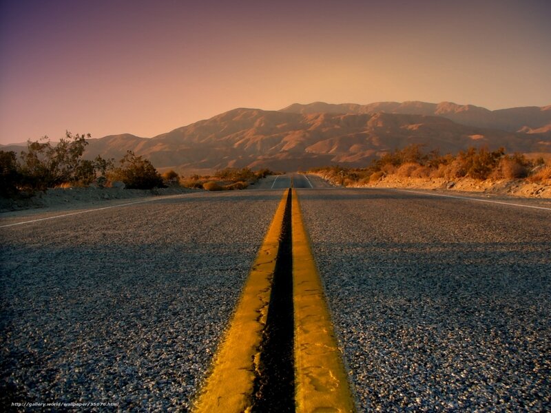 Desert road at sunset