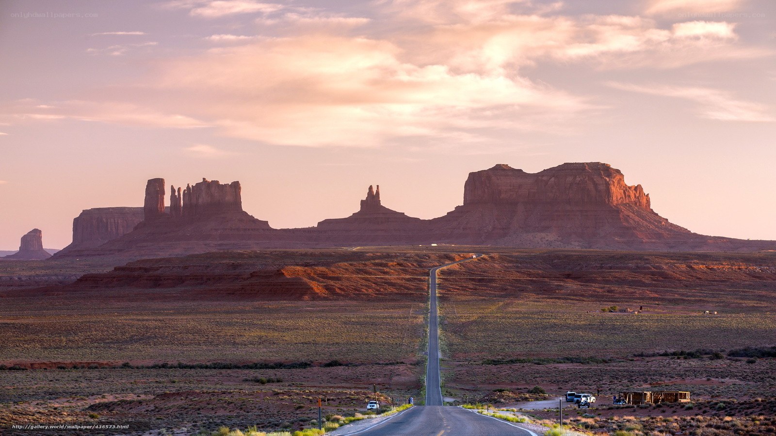 Desert road at sunset with rock formations