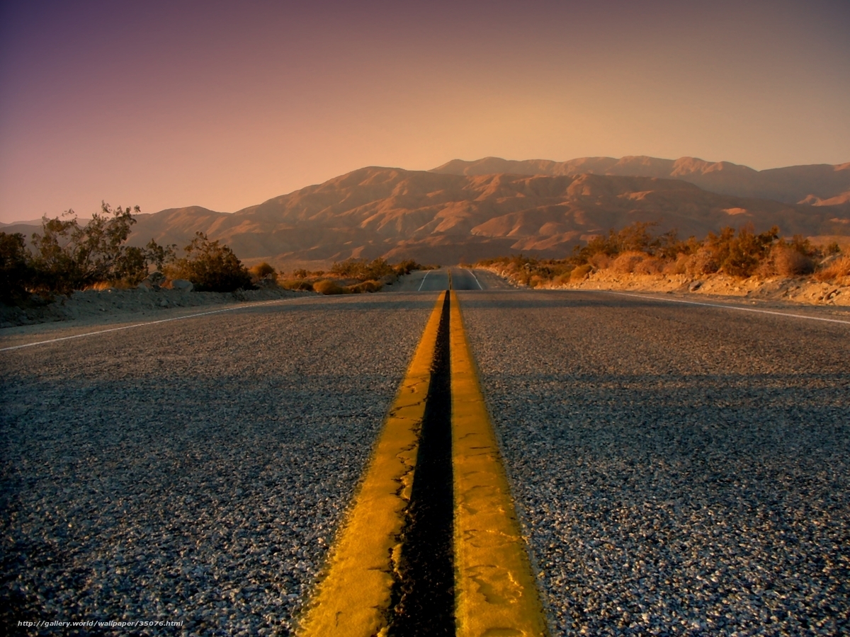 Desert road at sunset