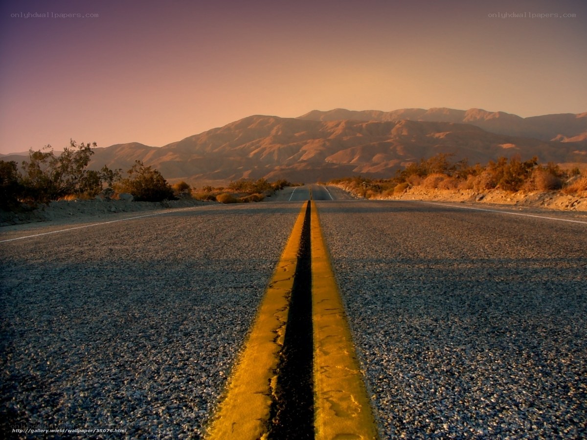 Desert road at sunset