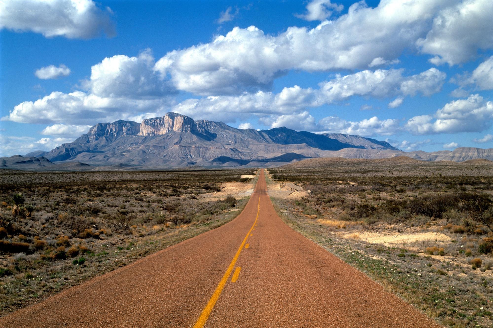 Desert road leading to mountains