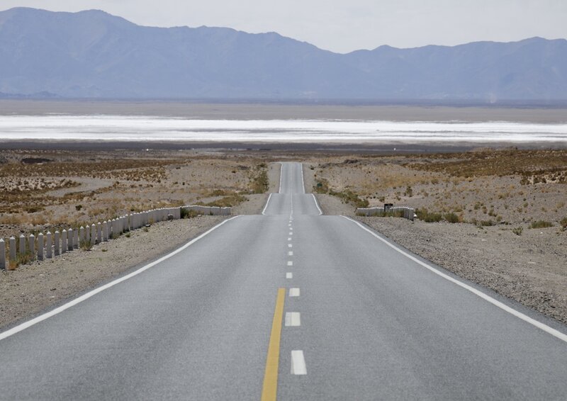 Desert road leading to salt flat