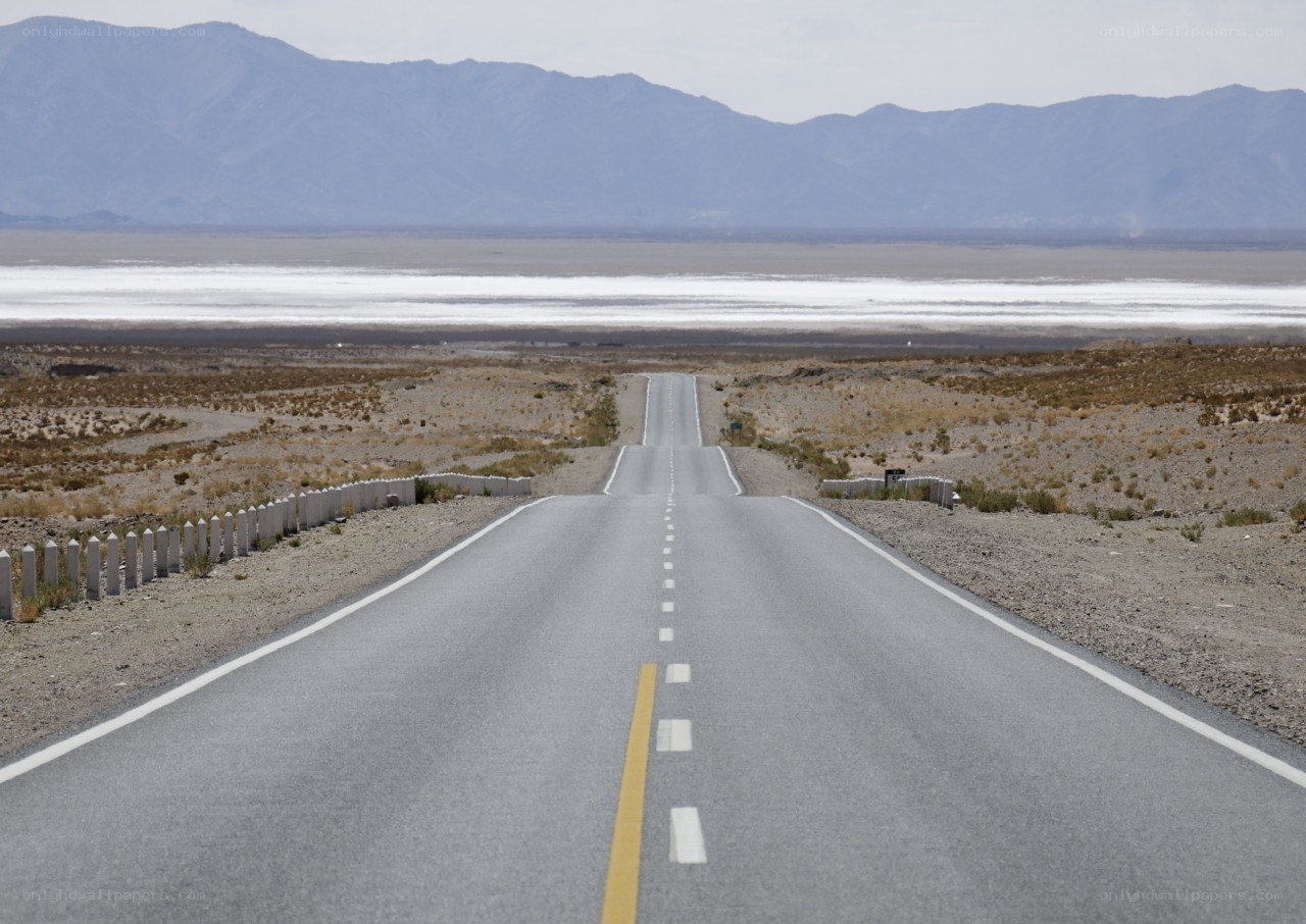 Desert road leading to salt flat