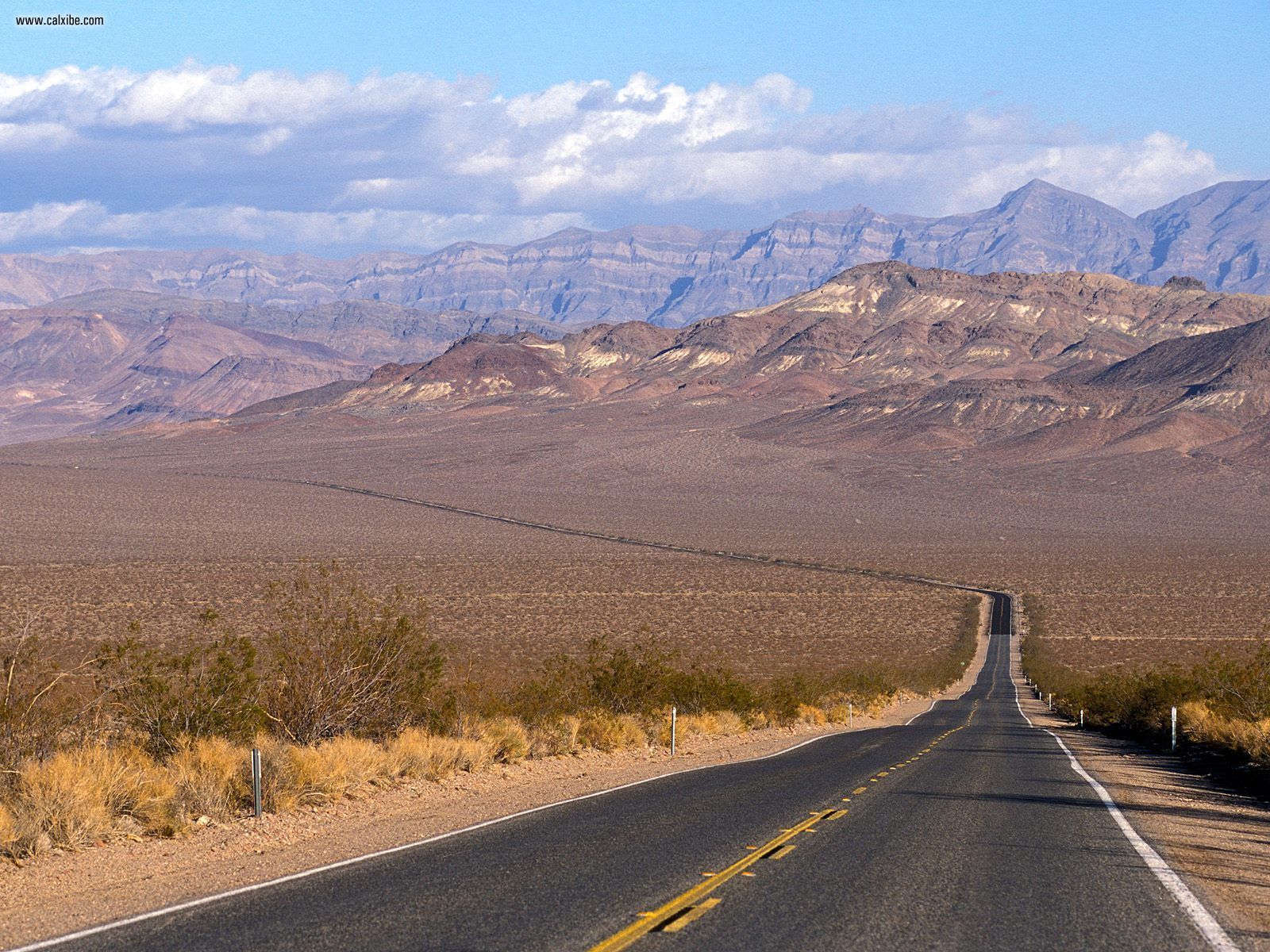 Desert road stretching into mountains