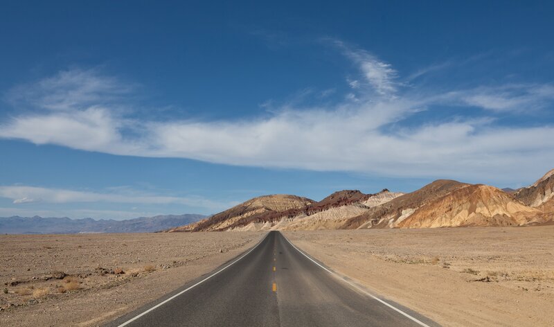 Desert road stretching to mountains