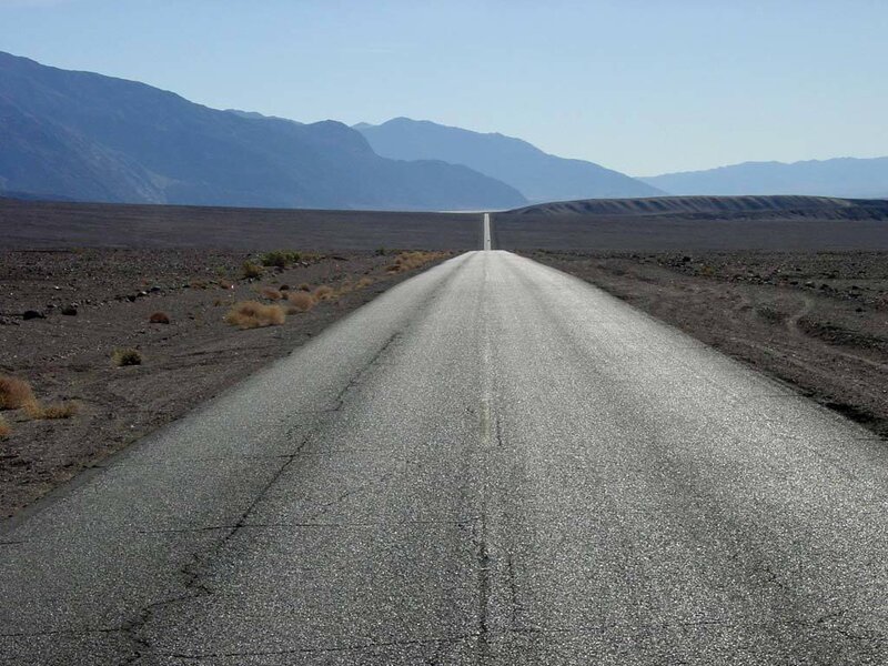 Desert road stretching to mountains