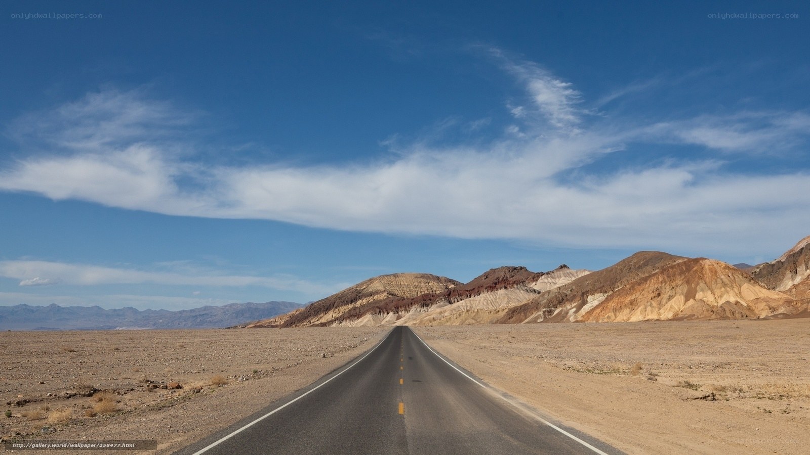 Desert road stretching to mountains