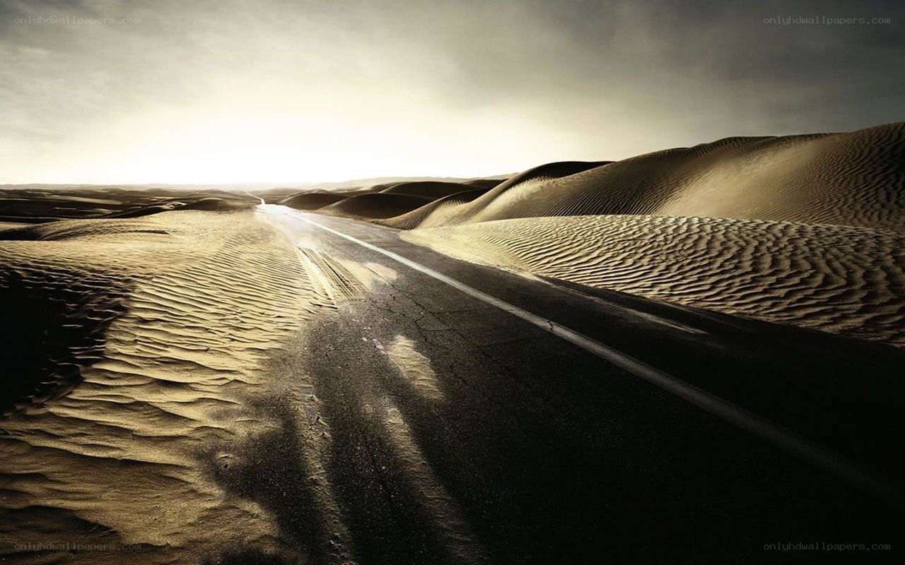 Desert road through sand dunes