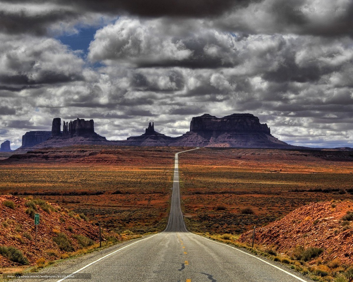 Desert road to rock formations