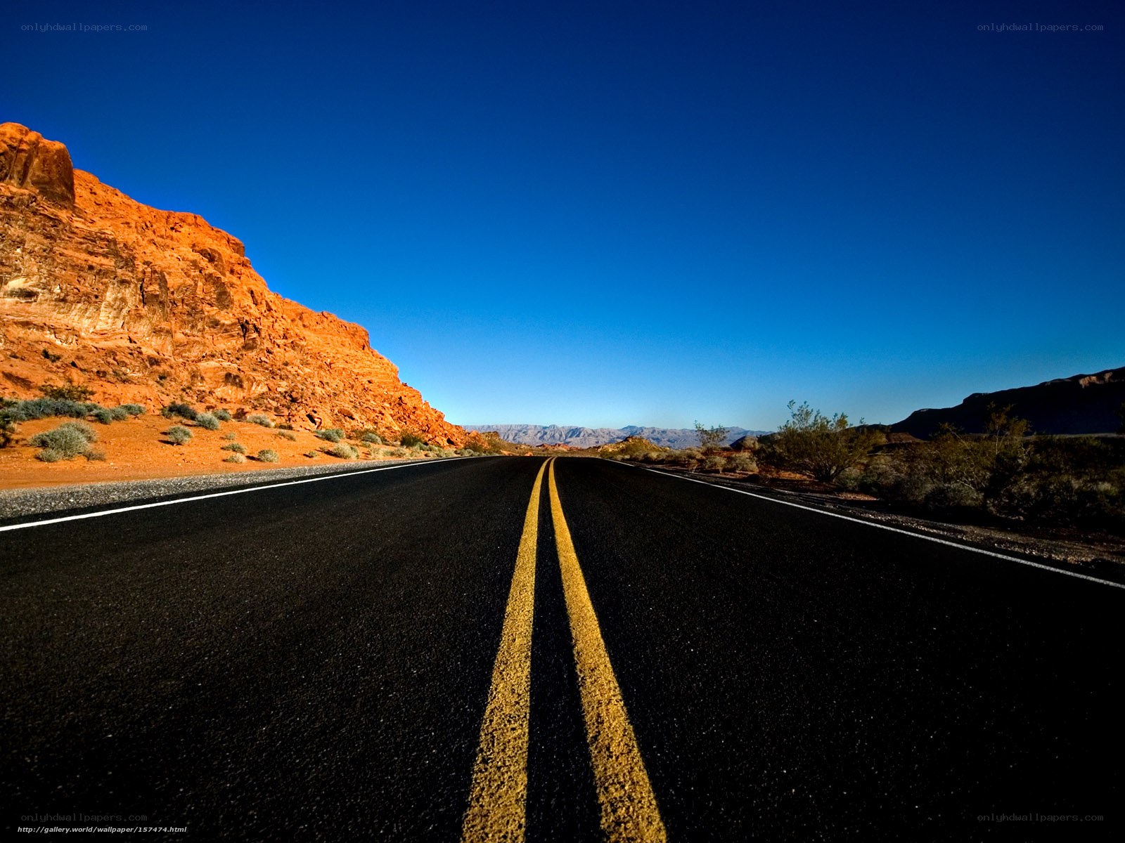 Desert road under blue sky
