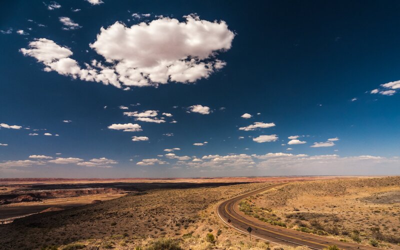 Desert road under blue sky