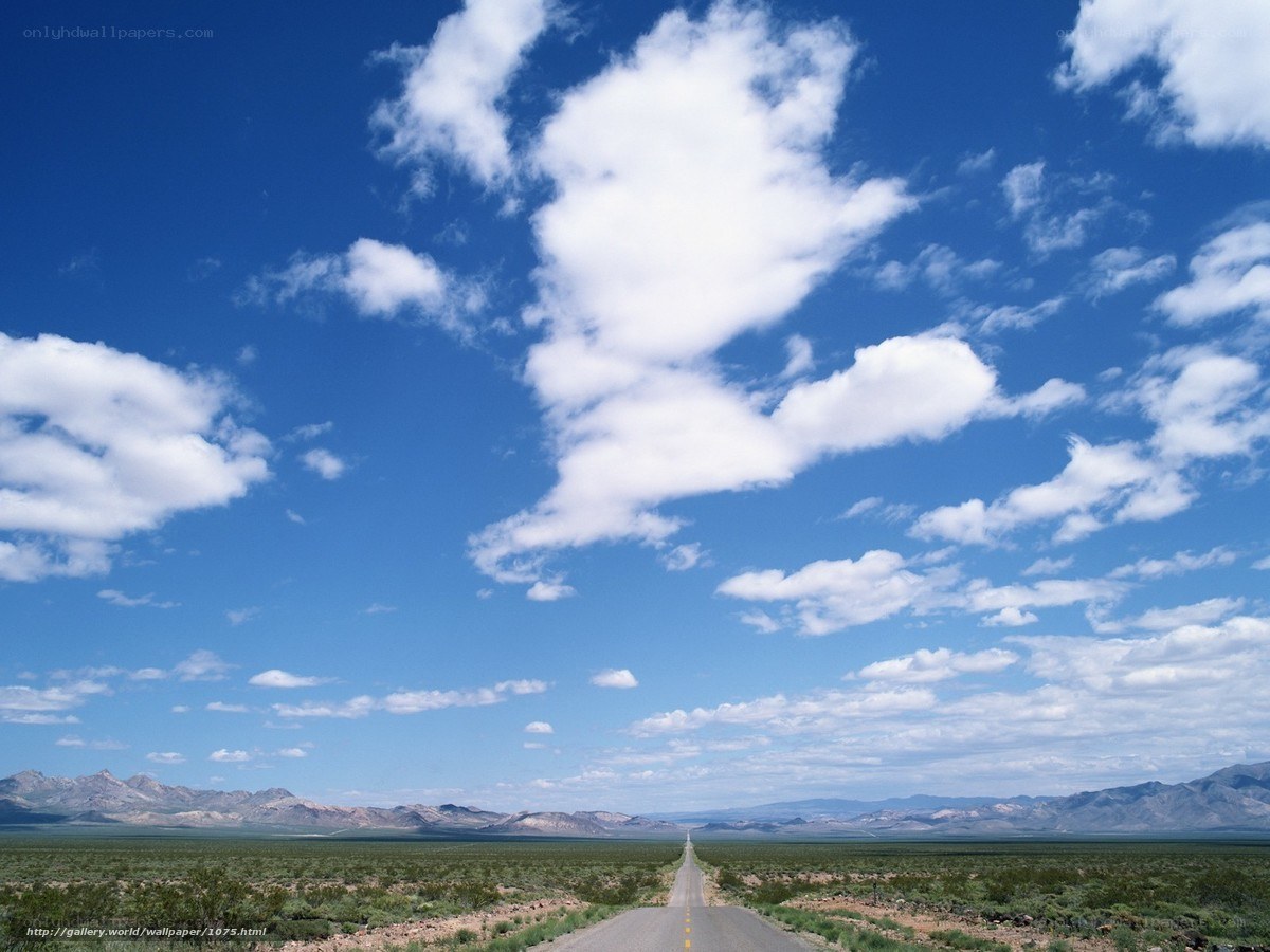 Desert road under blue sky