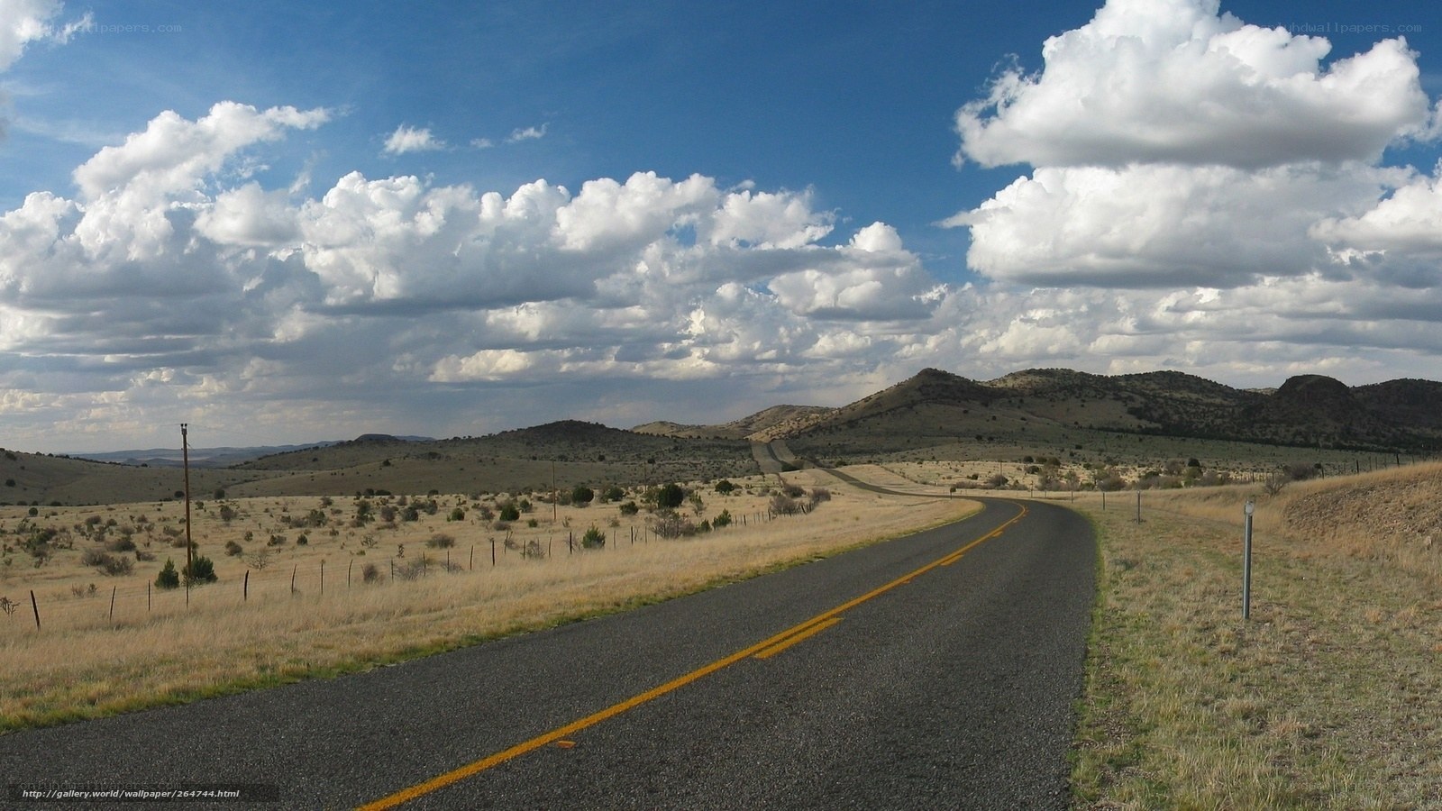 Desert road under cloudy sky