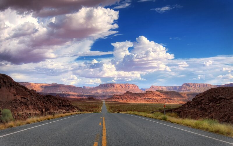 Desert road under cloudy sky