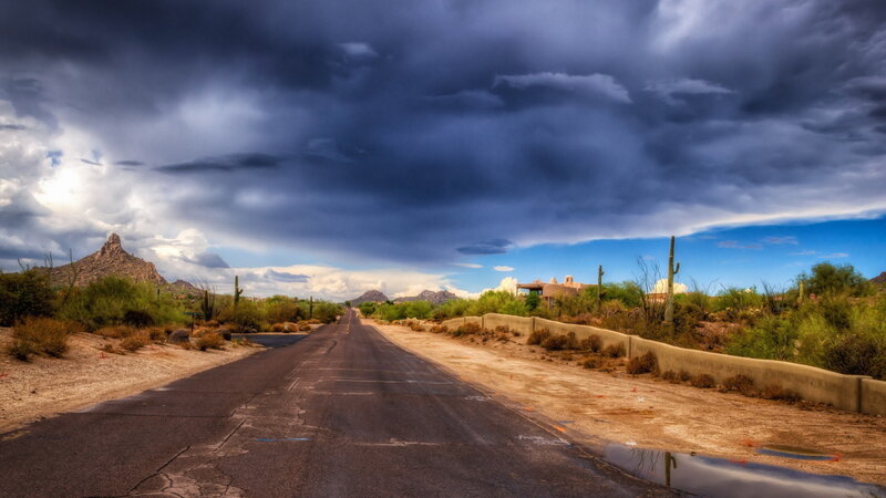 Desert Road under Storm Clouds