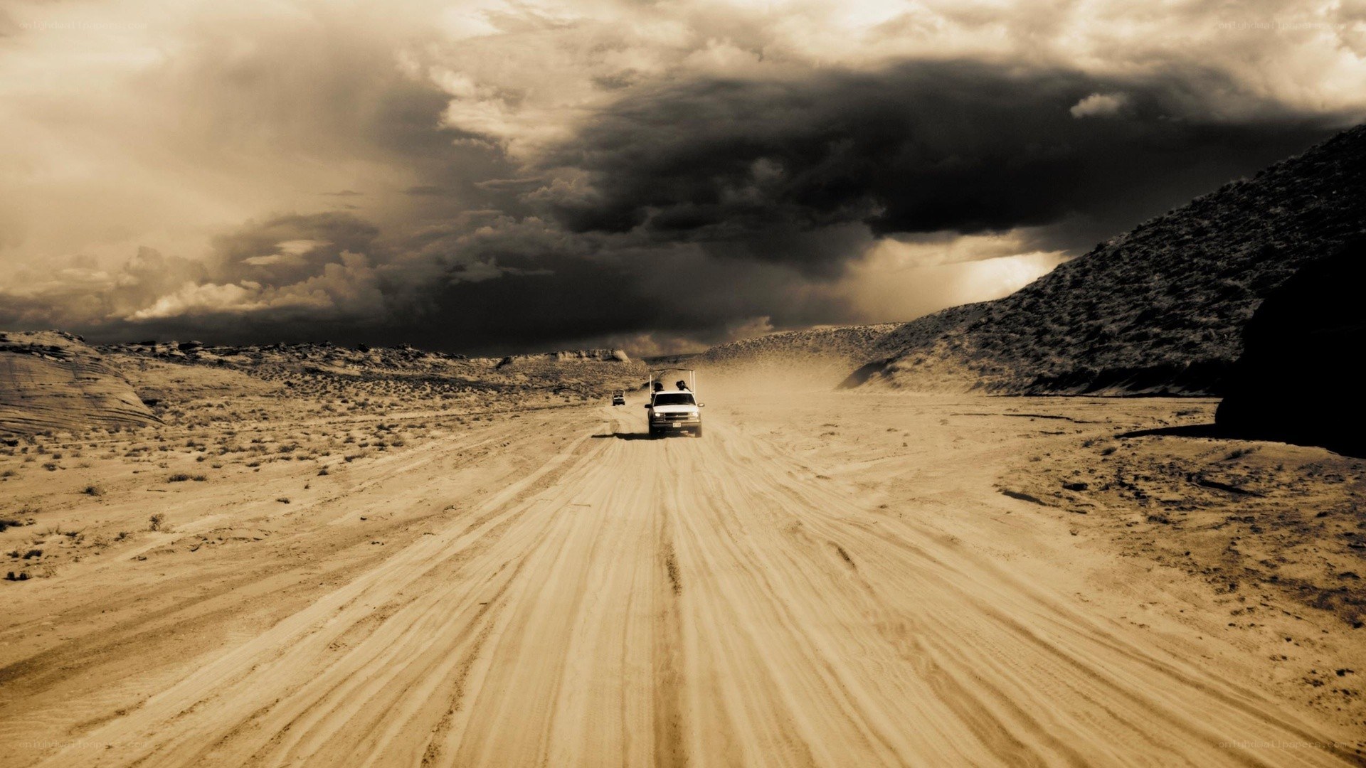 Desert road under stormy sky