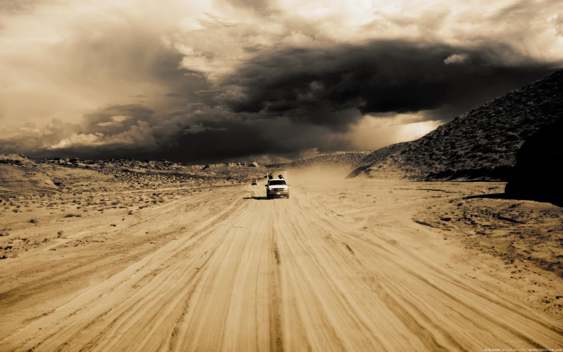 Desert road under stormy sky