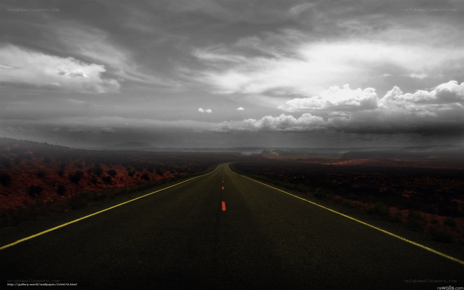 Desert road under stormy sky