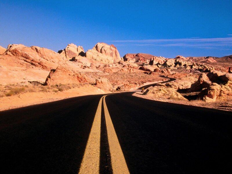Desert road winding through rock formations