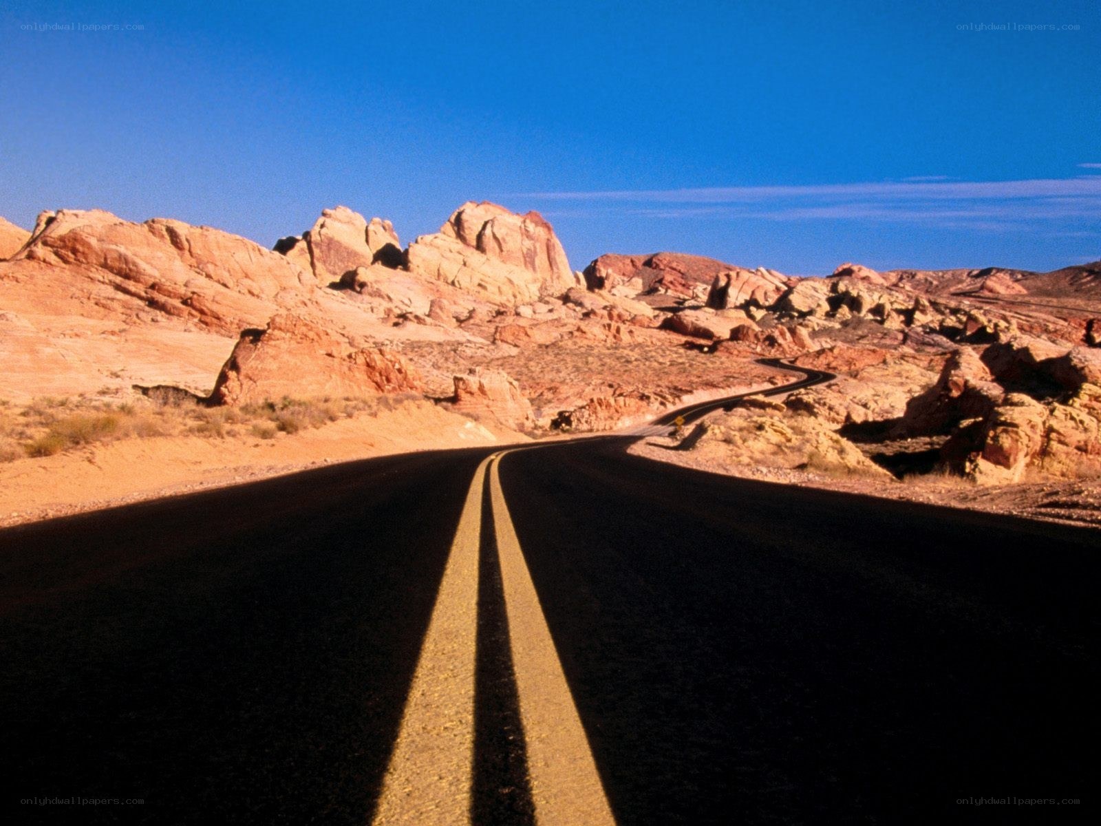 Desert road winding through rock formations