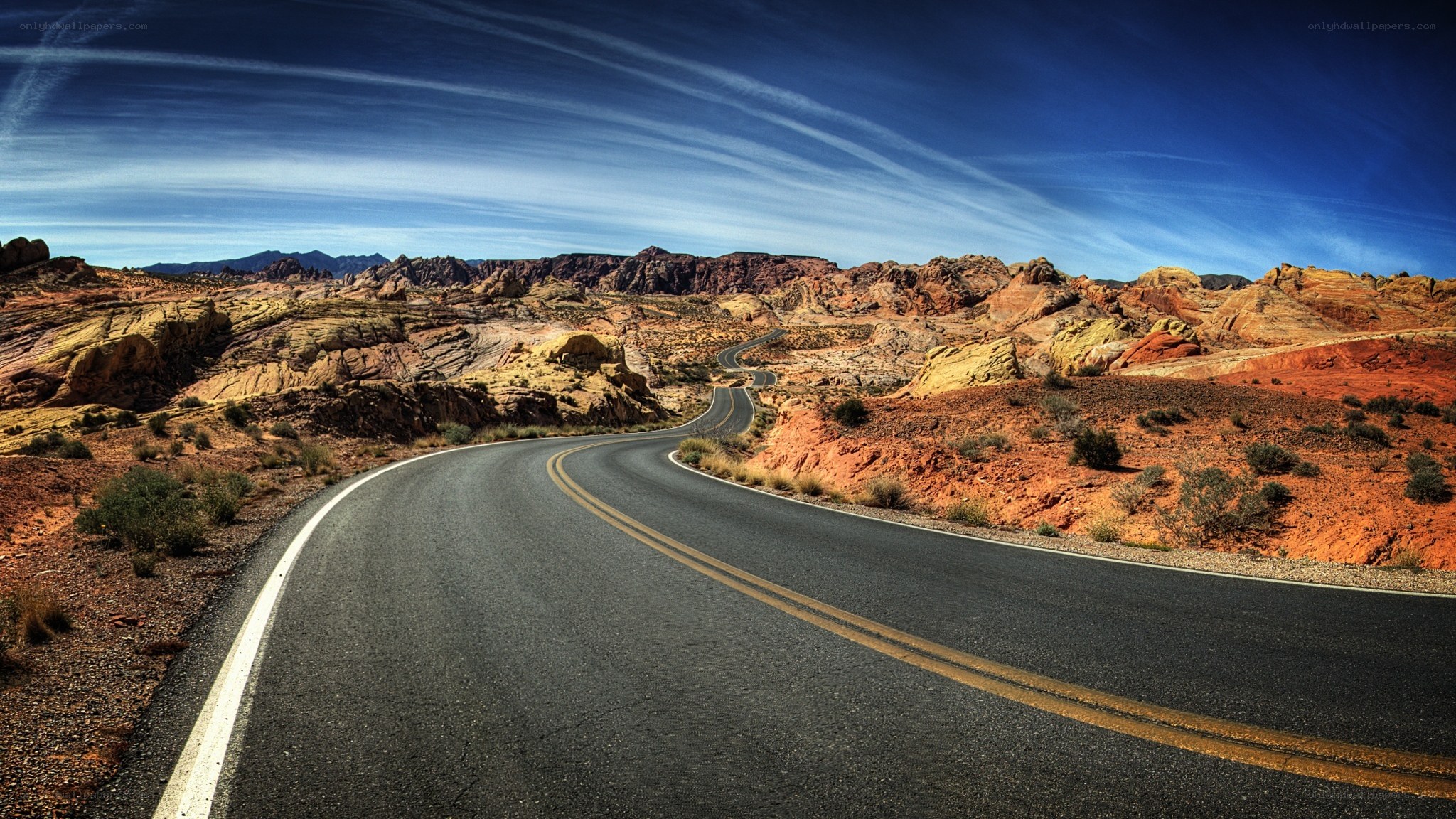 Desert road winding through rock formations