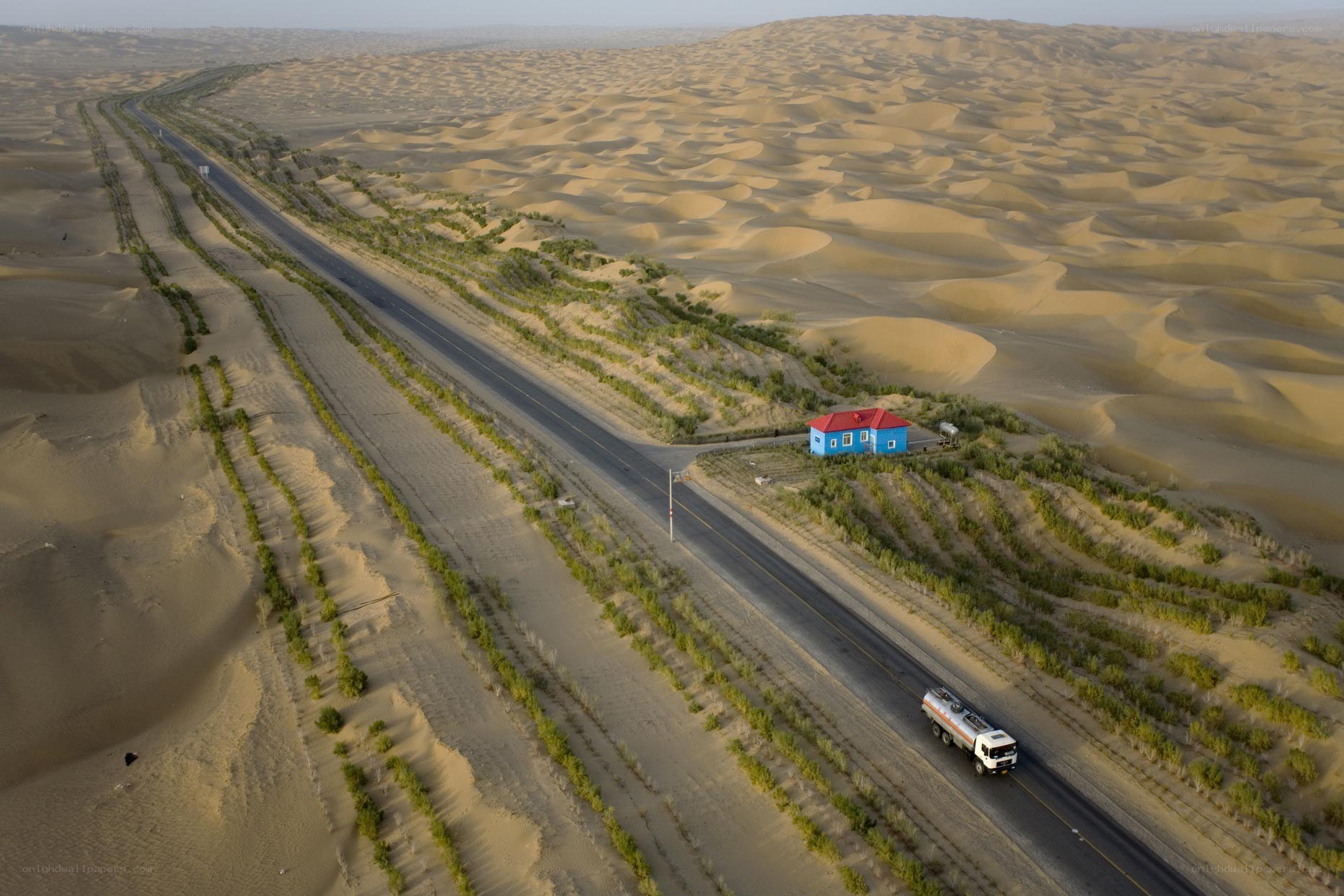 Desert road with blue house
