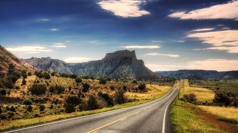 Desert road with mesa in distance