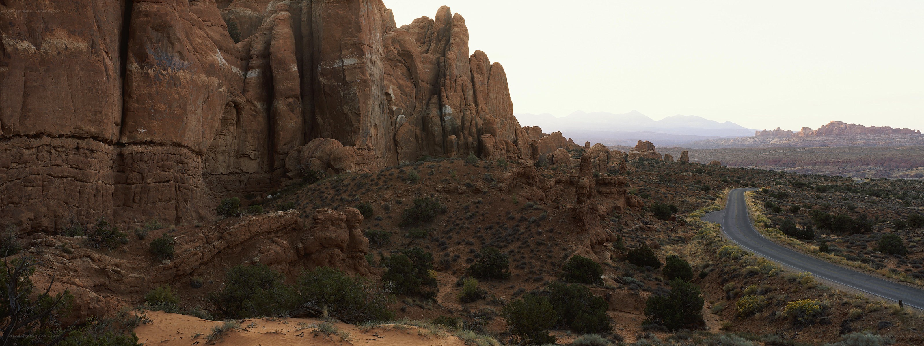 Desert road with red rock formations