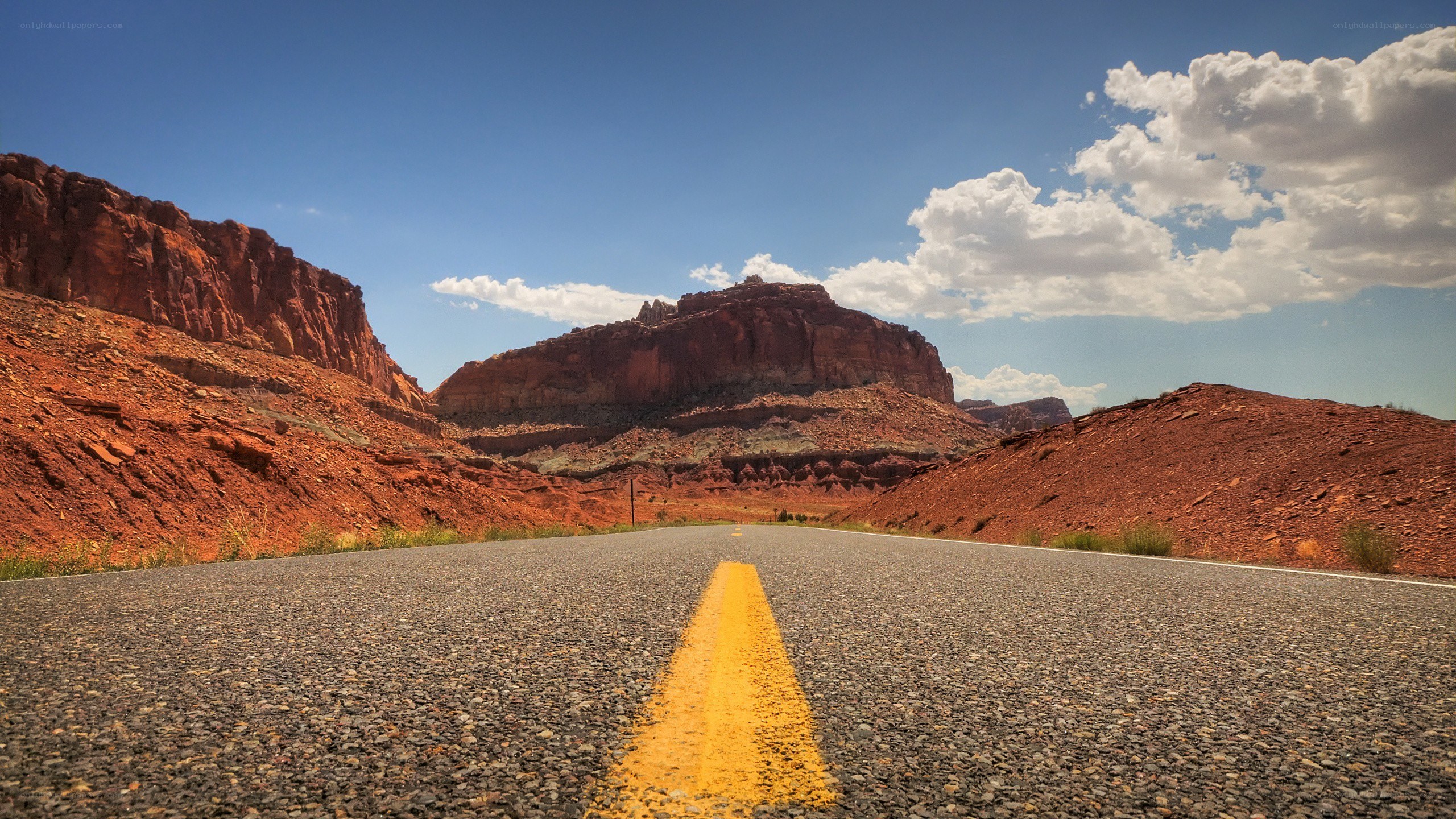 Desert road with red rock formations