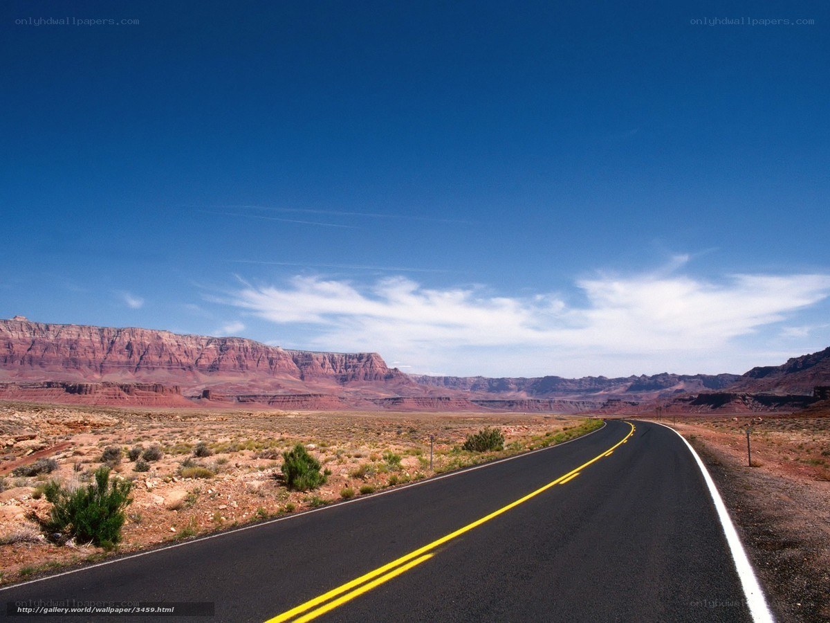 Desert road with red rock formations
