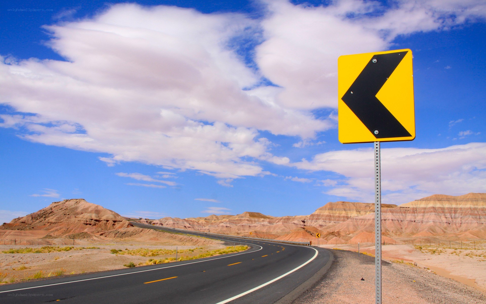 Desert road with winding sign